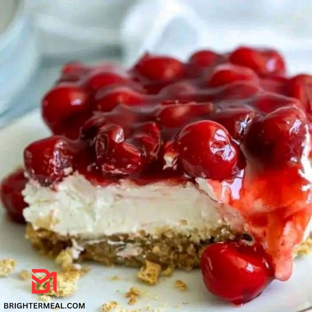 A close-up of delicious cherry cheesecake bars topped with vibrant cherry pie filling