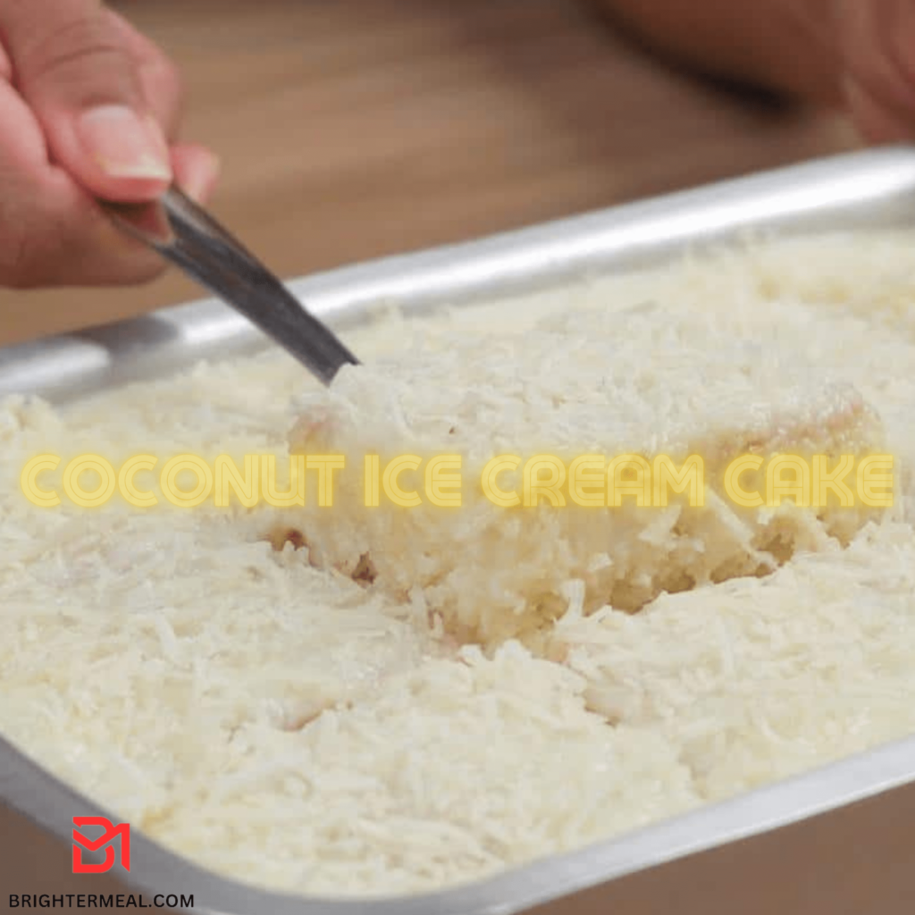 A slice of decadent coconut ice cream cake topped with whipped cream and toasted coconut flakes