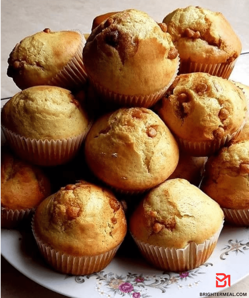 A close-up image of freshly baked muffins cooling on a wire rack, with steam rising, showcasing their golden-brown tops and tempting aroma.